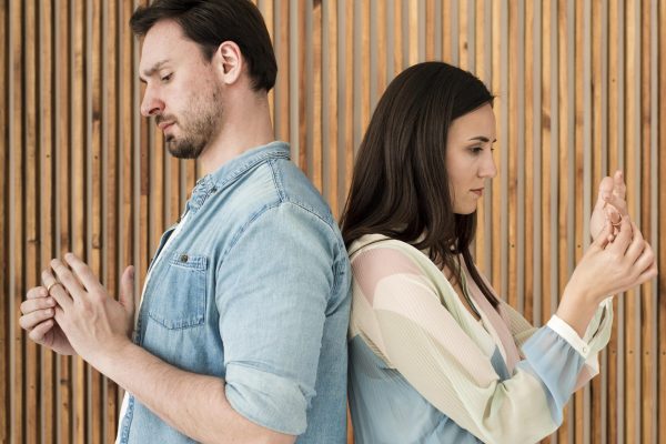 adult-man-woman-taking-wedding-rings-off